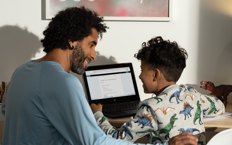 Dad with son on laptop