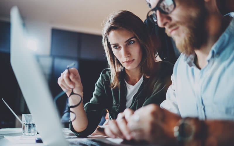 Two colleagues working together on a laptop