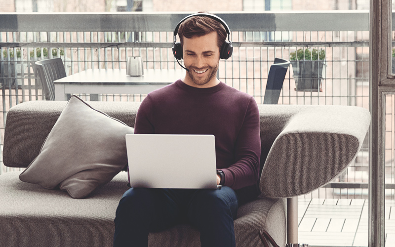 Man on sofa wearing Jabra Headset