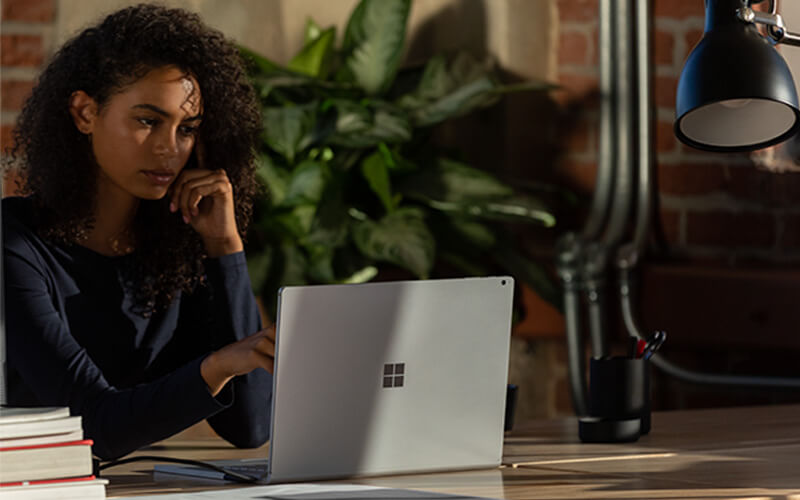 A woman using Surface Book 3 for Business