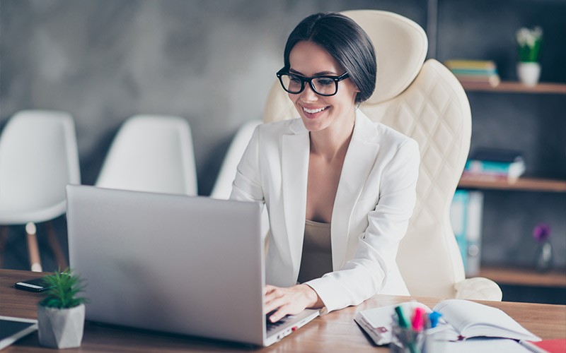 Communications to keep your business ready Woman working on a laptop in an office