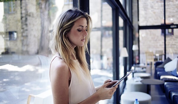 a woman working on a delivery with an employee using an apple device