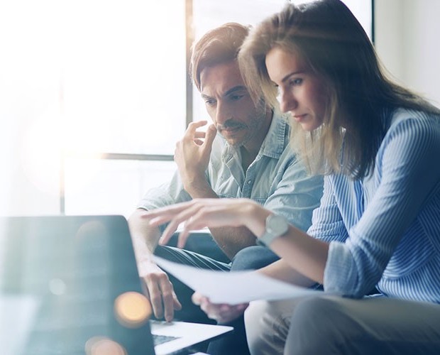 Man and woman working at laptop together
