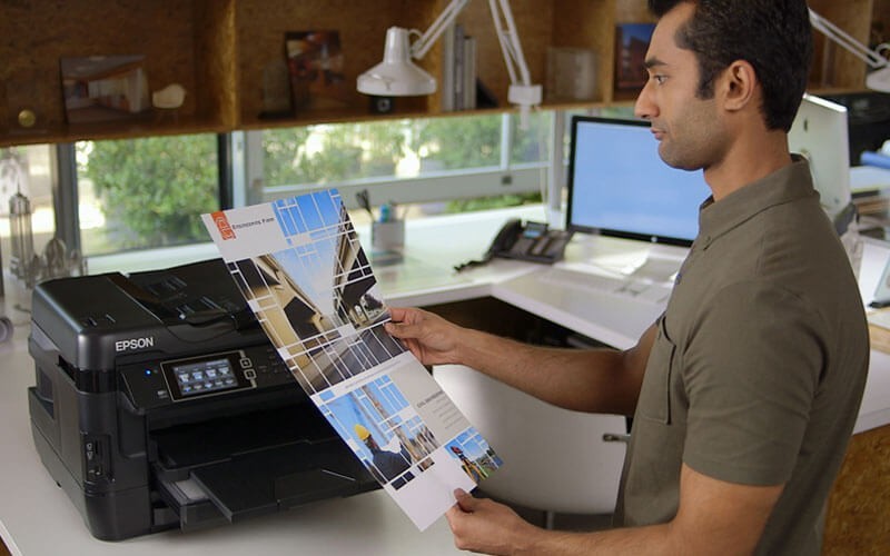 Epson printer Male creative designer printing marketing material at Epson printer