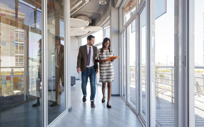 Man and woman walking through hallway