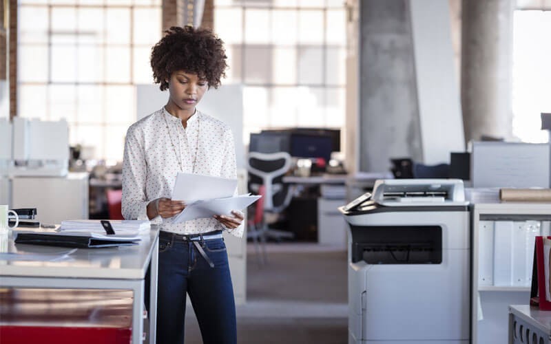 Woman looking through printed documents