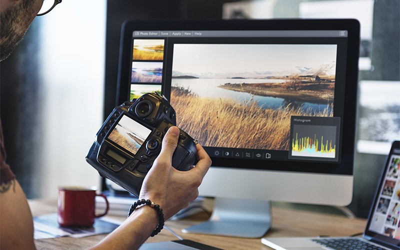 Find the right card for your needs. Man reviewing photos from DSLR camera