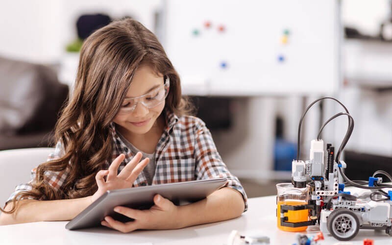 Access the latest professional learning and teaching tools Smiling student on tablet STEM learning
