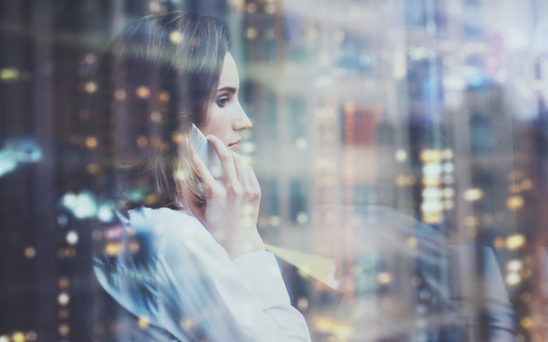 Future ready cloud with Intel Xeon processors Woman on cell phone through window and city lights