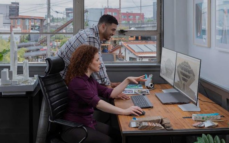 Securely transfer data Two colleagues working on a project on a laptop