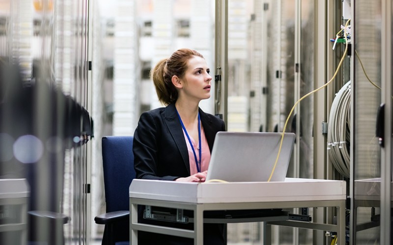 Keep your data secure and your performance uncompromised IT technician surveying servers in data centre