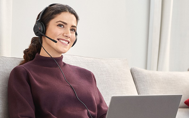 Man on sofa wearing Jabra Headset