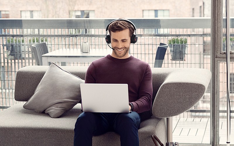 Man on sofa wearing Jabra Headset