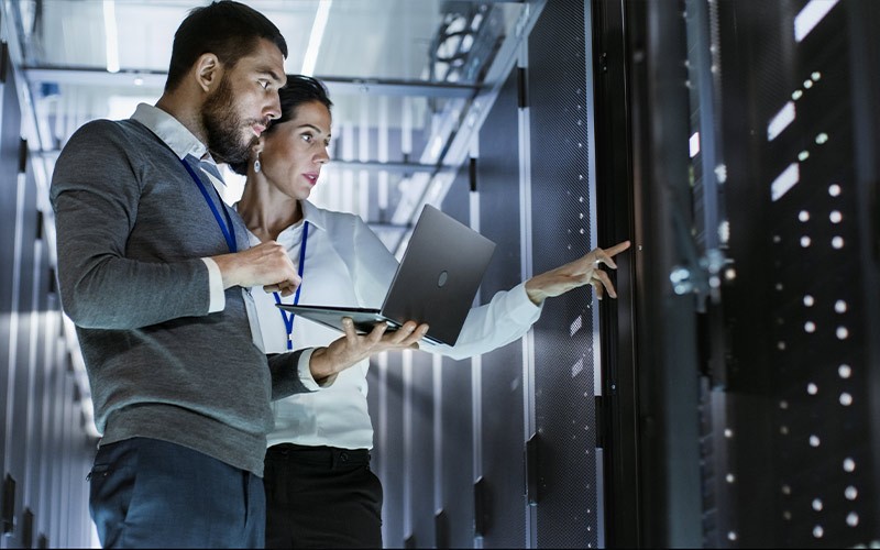 man and woman working in a server room