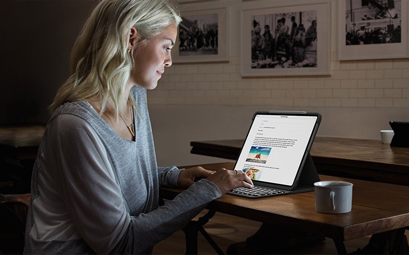 Woman working on an iPad at night.