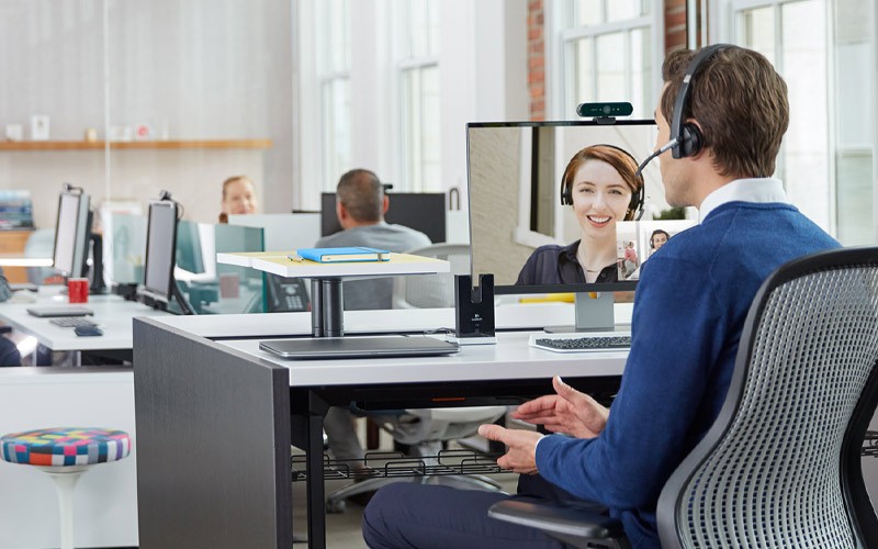 Man talking through a Logitech Bio webcam