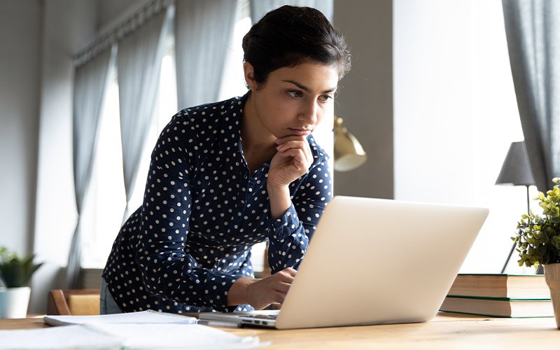 Learn more and get more access with Microsoft 365 E5 A woman studying infront of her laptop