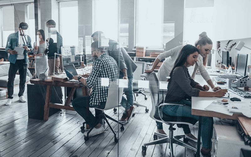 Protect your data on public or private clouds Various businessmen and women working in modern open office