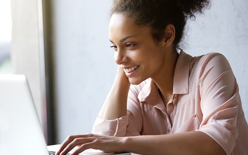 Riverbed delivers the only cloud-based SaaS acceleration service Woman smiling while using laptop
