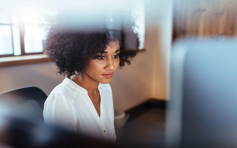 Centralised network security solutions Young professional woman sitting at laptop