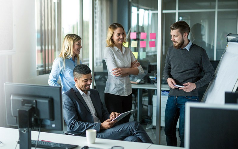 Group of employees collaborating in tech office